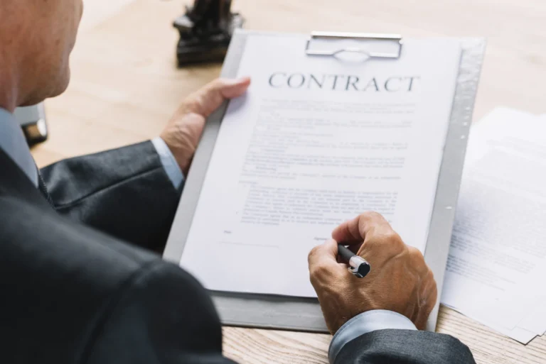 Business owner reviewing and signing a contract, representing contract law for Florida business owners.