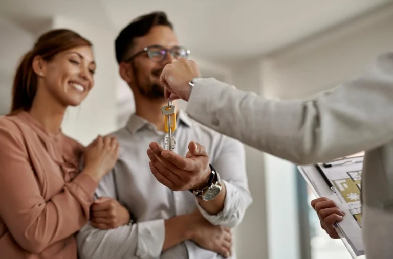 Happy couple receiving house keys, symbolizing a successful transaction under Florida real estate law.