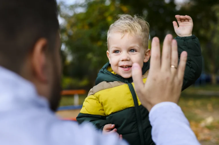 Parent and child interacting outdoors, representing child support enforcement and parental responsibility.