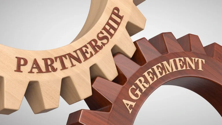 Interlocking gears labeled partnership and agreement symbolizing business collaboration.